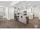Well-lit kitchen features granite countertops, stainless appliances, and modern pendant lighting at 415 Tayberry Ln, Fort Mill, SC 29715
