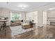 Spacious living room featuring a large sectional sofa, area rug, and natural light at 415 Tayberry Ln, Fort Mill, SC 29715