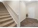 Carpeted staircase ascending from the entryway with a white railing and neutral wall color at 415 Tayberry Ln, Fort Mill, SC 29715