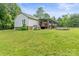 View of the back of the house with a large yard, deck, above ground pool and plenty of space to enjoy at 4155 Slanting Bridge Rd, Sherrills Ford, NC 28673