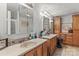 Bathroom featuring double sinks, wood cabinets, large mirrors and vanity lighting at 4155 Slanting Bridge Rd, Sherrills Ford, NC 28673