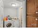 Practical laundry room with washer, dryer, and storage cabinets, making laundry tasks convenient at 4155 Slanting Bridge Rd, Sherrills Ford, NC 28673