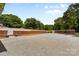 This fenced backyard features a brick fence, well maintained landscaping and a large gravel driveway at 4600 Beatties Ford Rd, Charlotte, NC 28216