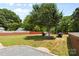 A serene backyard featuring two dog houses and a hammock strung between mature trees at 4600 Beatties Ford Rd, Charlotte, NC 28216