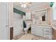 This bathroom features a shower and tub combo, plus a single vanity with marble counters, and modern fixtures and a window for light at 4600 Beatties Ford Rd, Charlotte, NC 28216
