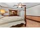 This bedroom features a four poster bed, ceiling fan, a wooden dresser and matching furnishings plus a soothing color scheme at 4600 Beatties Ford Rd, Charlotte, NC 28216