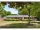 Charming single-story brick home with lush green lawn and manicured hedges in a desirable neighborhood at 4600 Beatties Ford Rd, Charlotte, NC 28216