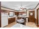 Functional kitchen with wood cabinets, tile countertops, and a cozy breakfast nook at 4600 Beatties Ford Rd, Charlotte, NC 28216