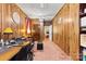 This office space features natural wood paneling, classic desk and furnishings and doorway views to the rest of the house at 4600 Beatties Ford Rd, Charlotte, NC 28216