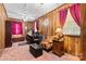 Comfortable home office with wood paneling, carpet floors, and ample natural light at 4600 Beatties Ford Rd, Charlotte, NC 28216