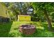 Backyard space with a fire pit and yellow shed in a lush setting at 509 S Clay St, Gastonia, NC 28052