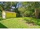 Lush backyard space with mature trees, a yellow shed and low ground cover at 509 S Clay St, Gastonia, NC 28052