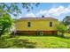 Back of home with backyard featuring a fire pit and lush greenery at 509 S Clay St, Gastonia, NC 28052