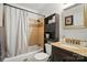 Full bath featuring a shower and bath combination and dark cabinets at 509 S Clay St, Gastonia, NC 28052