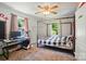 Bedroom with carpet, windows, and a metal frame bed at 509 S Clay St, Gastonia, NC 28052