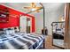A modern bedroom features a bed with a black and white comforter and a red accent wall at 509 S Clay St, Gastonia, NC 28052