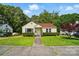 Charming yellow bungalow with red roof, well-maintained lawn, and lush green trees surrounding the property at 509 S Clay St, Gastonia, NC 28052