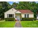 Charming yellow bungalow with red roof, landscaped front yard, and inviting front porch entrance at 509 S Clay St, Gastonia, NC 28052