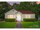 Charming yellow bungalow with red roof, landscaped front yard, and inviting front porch entrance at 509 S Clay St, Gastonia, NC 28052