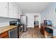 Spacious kitchen featuring stainless appliances, warm wood floors, and a laundry room entrance at 509 S Clay St, Gastonia, NC 28052