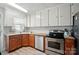 Classic kitchen features oak cabinets, stainless steel appliances, and granite countertops at 509 S Clay St, Gastonia, NC 28052