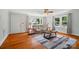 Bright living room with hardwood floors, large windows, and comfortable seating arrangement with a large area rug at 509 S Clay St, Gastonia, NC 28052