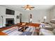 Cozy living room features a stone fireplace, ceiling fan, wood floors and a modern area rug at 509 S Clay St, Gastonia, NC 28052