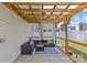 Relaxing outdoor living space with comfortable seating under a wood pergola and ceiling fan at 5325 Merwyn Ave, Charlotte, NC 28215