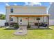 Spacious backyard with covered patio seating, grill, and firepit at 5325 Merwyn Ave, Charlotte, NC 28215