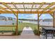 Outdoor wooden patio structure with a grill and firepit in a well-kept fenced backyard at 5325 Merwyn Ave, Charlotte, NC 28215