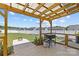 Covered backyard patio with a grill, firepit, and spacious fenced backyard at 5325 Merwyn Ave, Charlotte, NC 28215