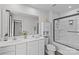 The bathroom features double sinks and a glass enclosed shower and sleek white cabinets at 5325 Merwyn Ave, Charlotte, NC 28215