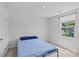 Bedroom with a blue bedspread, neutral walls, and lots of natural light from the window at 5325 Merwyn Ave, Charlotte, NC 28215