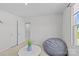 Bonus room featuring a grey beanbag chair, modern table, and neutral carpet at 5325 Merwyn Ave, Charlotte, NC 28215