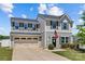 Charming two-story home showcasing well-maintained landscaping, attached garage, and a welcoming entryway at 5325 Merwyn Ave, Charlotte, NC 28215