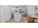 Modern kitchen featuring an island, stainless steel appliances, and white cabinetry with a dining area at 5325 Merwyn Ave, Charlotte, NC 28215