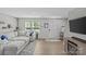 Comfortable living room with a large sectional, stylish decor, and a view of the outdoors through bright windows at 5325 Merwyn Ave, Charlotte, NC 28215