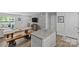 Open living room with eat-in kitchen, dining table, TV, and door to the front entrance at 5325 Merwyn Ave, Charlotte, NC 28215