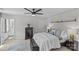 The bedroom features neutral walls, and patterned wallpaper accent wall, and a ceiling fan at 5325 Merwyn Ave, Charlotte, NC 28215