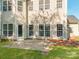Backyard view featuring a concrete patio and ample natural light streaming through multiple windows at 533 Montgrove Nw Pl, Concord, NC 28027