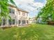 Spacious backyard with lush green lawn, showcasing the home's exterior and neighborhood surroundings at 533 Montgrove Nw Pl, Concord, NC 28027