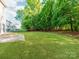 Expansive backyard featuring a lush lawn and mature trees, creating a serene outdoor space at 533 Montgrove Nw Pl, Concord, NC 28027