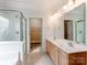 Bathroom featuring dual sinks, a shower stall, and a separate door leading to a walk-in closet at 533 Montgrove Nw Pl, Concord, NC 28027