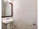 The powder room features a pedestal sink, classic mirror, and neutral paint at 533 Montgrove Nw Pl, Concord, NC 28027