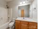 Bathroom featuring a tub with shower, vanity, and a large mirror at 533 Montgrove Nw Pl, Concord, NC 28027
