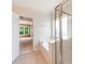 Bright bathroom showcases a soaking tub and shower stall with a glimpse into an adjacent naturally lit bedroom at 533 Montgrove Nw Pl, Concord, NC 28027