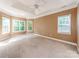 Primary bedroom boasts natural light, a ceiling fan, and tray ceiling with crown molding detail at 533 Montgrove Nw Pl, Concord, NC 28027