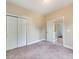 Bright bedroom with neutral walls, carpet and a closet at 533 Montgrove Nw Pl, Concord, NC 28027