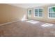 Bright, naturally lit bedroom with three windows providing ample light and a welcoming atmosphere at 533 Montgrove Nw Pl, Concord, NC 28027