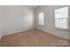 Neutral bedroom features carpet, lots of light and a blank canvas for personalization at 533 Montgrove Nw Pl, Concord, NC 28027